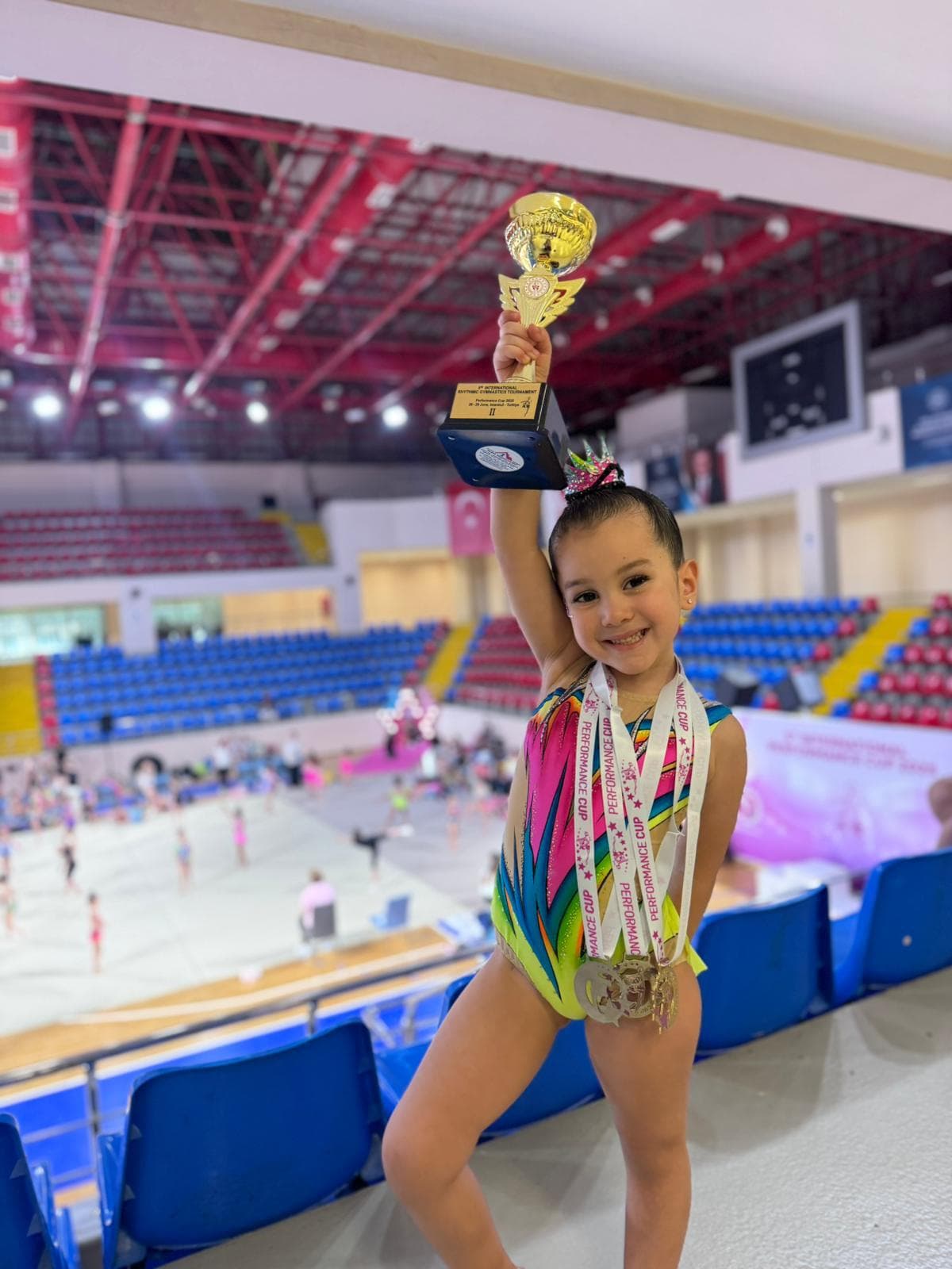 Young gymnast with trophy at international competition